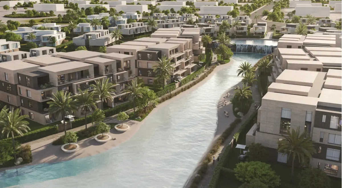 31 West – Aerial view of a long lagoon with a cascade between stone-clad apartments