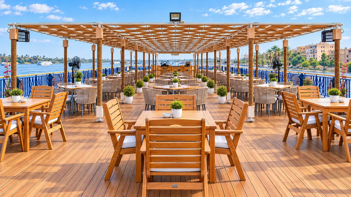 Amwaj Boat Renovation – Open upper-deck dining terrace under a timber pergola beside the river