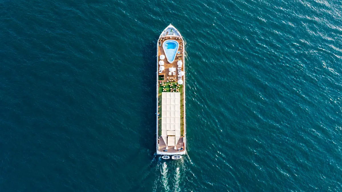 Amwaj Boat Renovation – Top-down aerial view of the boat and its sun-deck pool on deep blue water