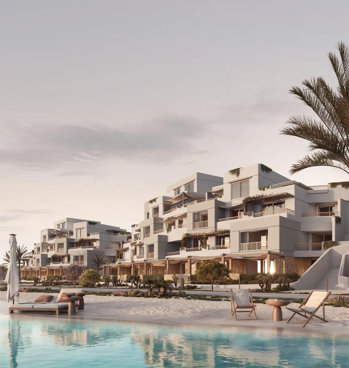 Oyster at Masyaf – Terraced apartments above a sandy lagoon beach with loungers in soft evening light