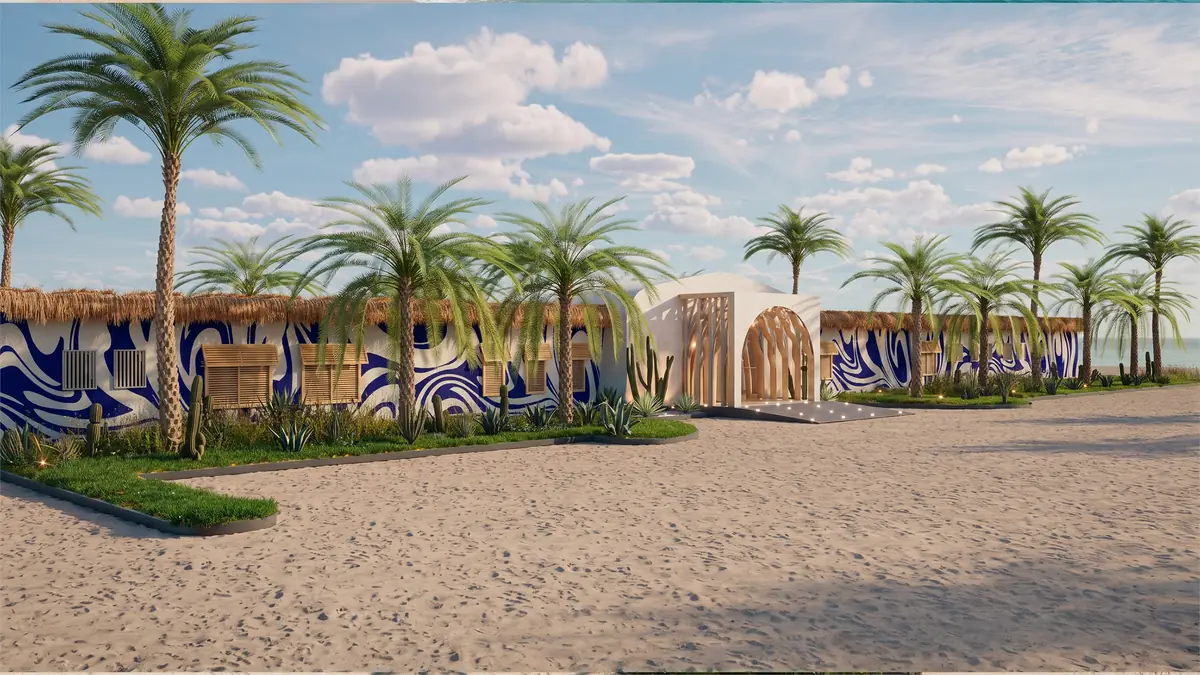 The Spot – Kite Center – أسوار مرسومة بنقوش أمواج زرقاء خلف أشجار النخيل والرمال